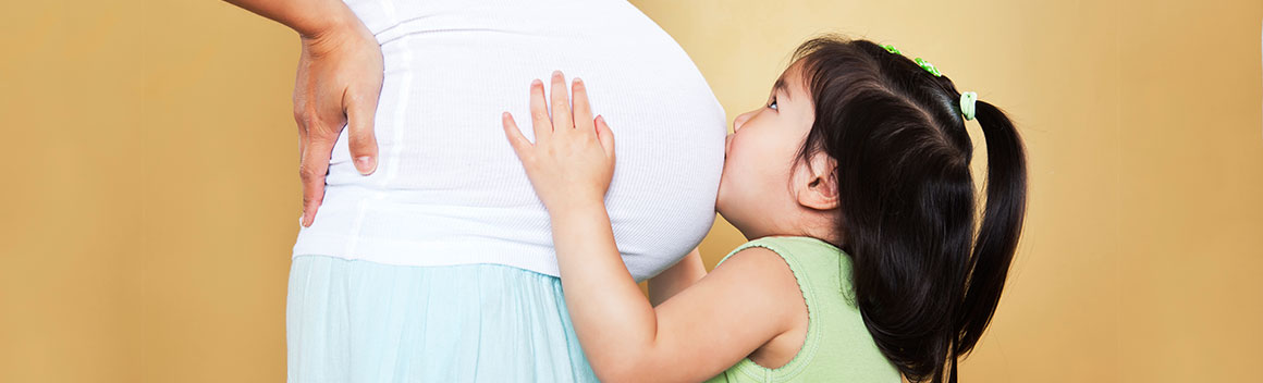 Big sister with pregnant belly